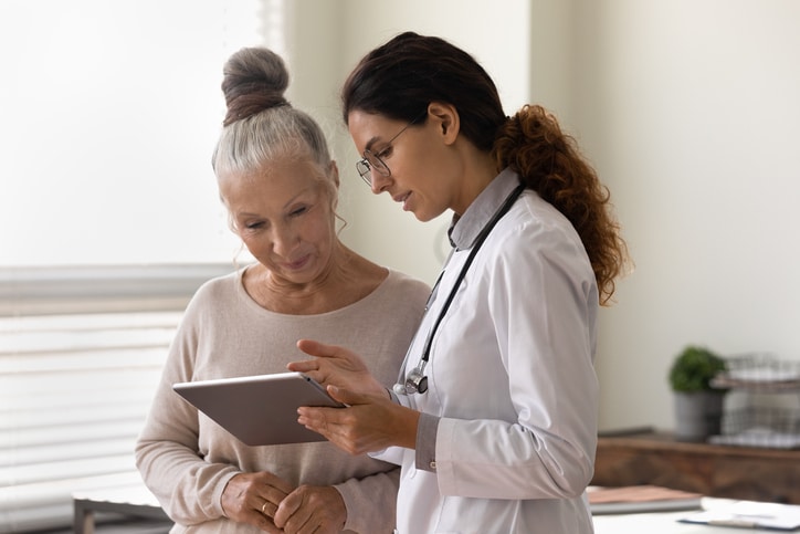 Doctor showing tablet screen to a patient