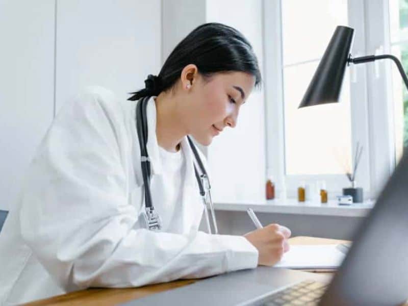 Doctor writing on a white paper