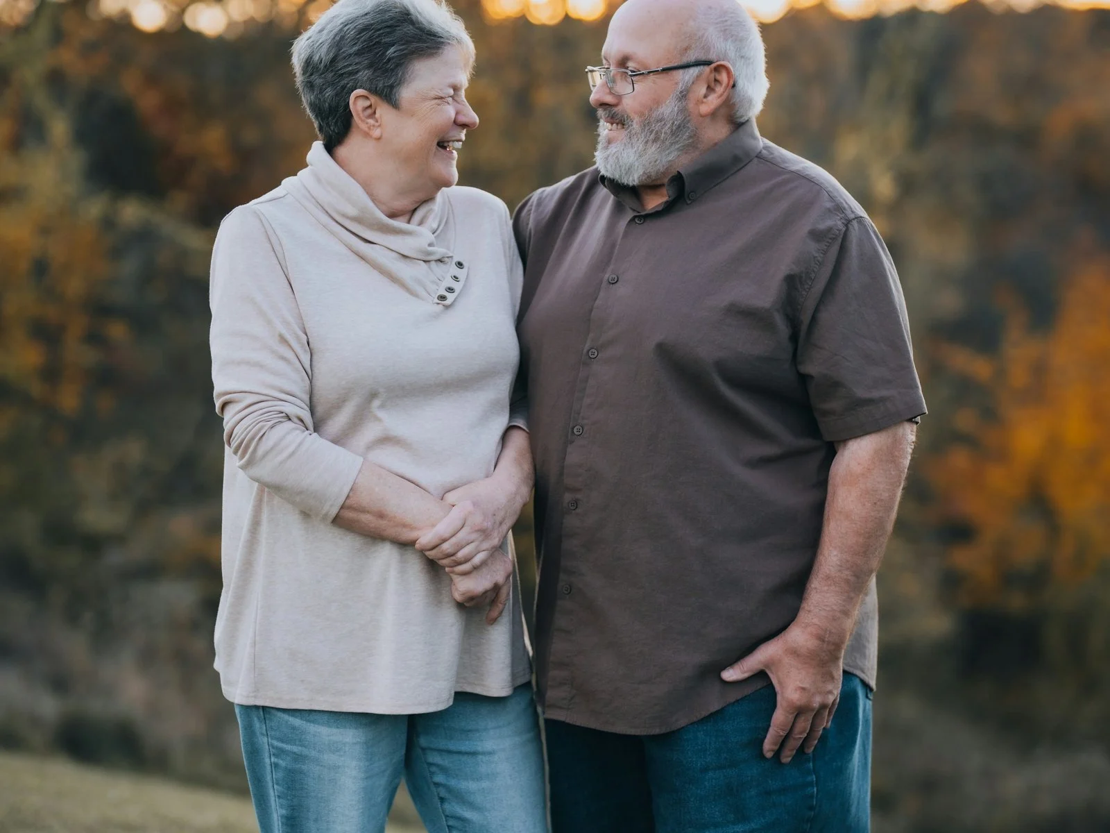 A patient in remission with his wife, outdoors in autumn light